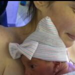 Elizabeth sostiene a su hija recién nacida