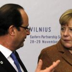 La canciller alemana, Angela Merkel, conversa con el presidente francés, François Hollande, al inicio de la cumbre de Vilna