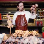 El cocinero Stefan del Río, rodeado de coquelets, y demás aves, delante de la mesa de trabajo del restaurante Aire, de reciente inauguración.