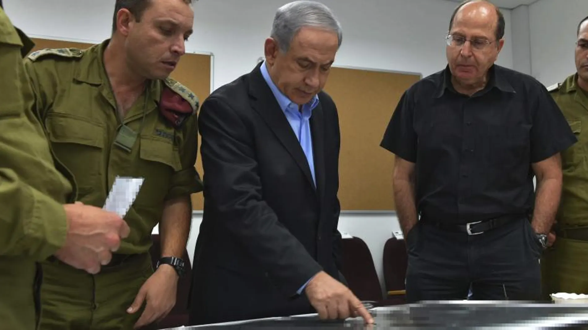 El primer ministro israelí, Benjamín Netanyahu (c), y el ministro de Defensa israelí, Moshe Yaalon (2d), durante su visita al Comando Sur del ejército israelí.
