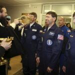 Un cura bendice (i-d) al astronauta ruso Gennady Padalka, que ejerce de comandante, al astronauta estadounidense Michael Barrat y al turista espacial estadounidense Charles Simonyi