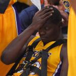 Los Angeles Lakers forward Julius Randle, right, sits on on a stretcher after Randle injured himself on a play during the second half of an NBA basketball game, Tuesday, Oct. 28, 2014, in Los Angeles. (AP Photo/Mark J. Terrill)