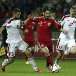 El centrocampista de la selección española, Isco (c), intenta llevarse el balón ante los jugadores de Bielorrusia, Sergey Kislyak (i) y Pavel Nekhajchik