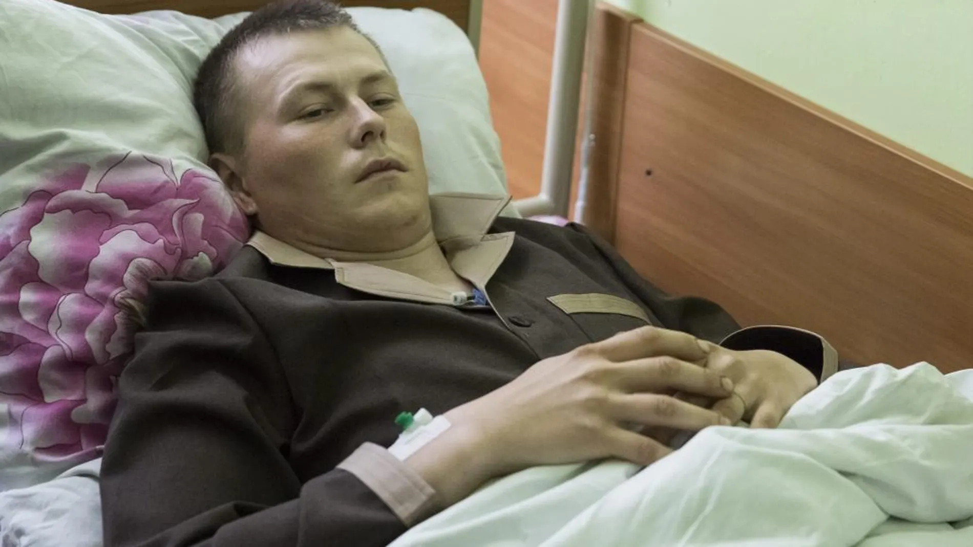 Alexandr Alexándrov, un ciudadano ruso detenido en Ucrania, descansa en la cama de un hospital de Kiev