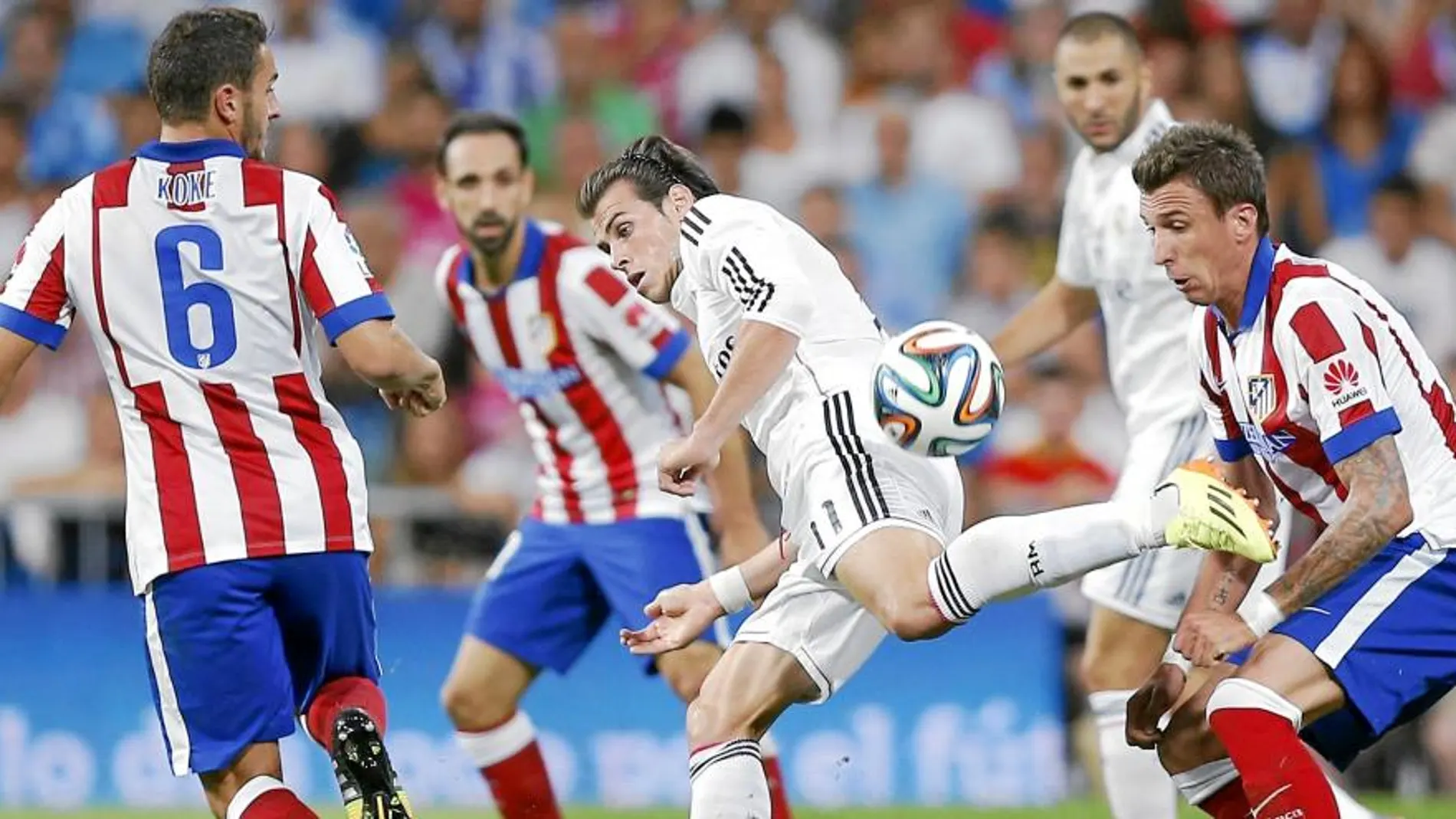 Bale, que fue uno de los más activos del Real Madrid, intenta eludir la presión de Koke y Mandzukic