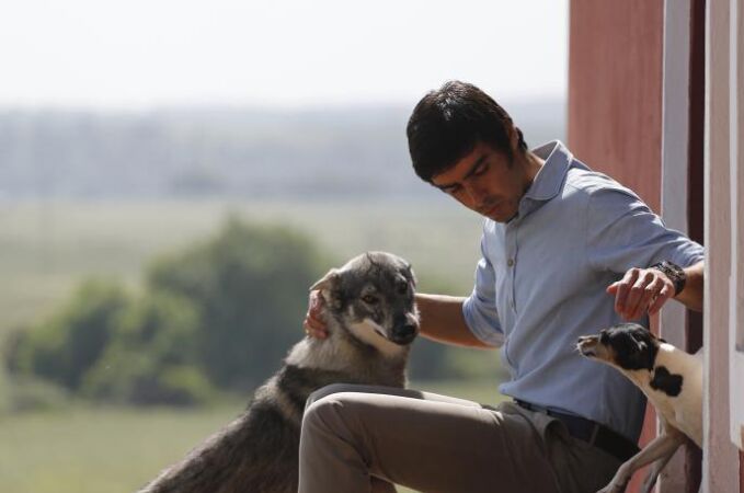 Miguel Ángel Perera con «Beba», una loba que convive pacíficamente con sus perros, en la finca de «Los Cansaos».