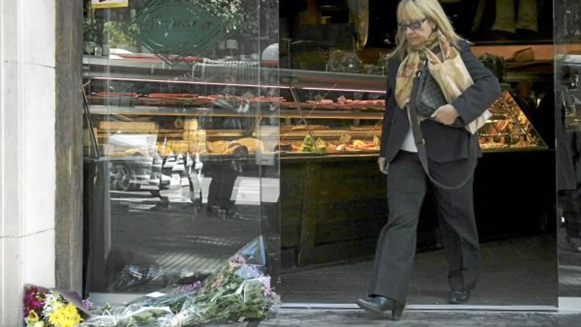 En la imagen, la panadería escenario del crimen con unas flores que rememoran el trágico suceso