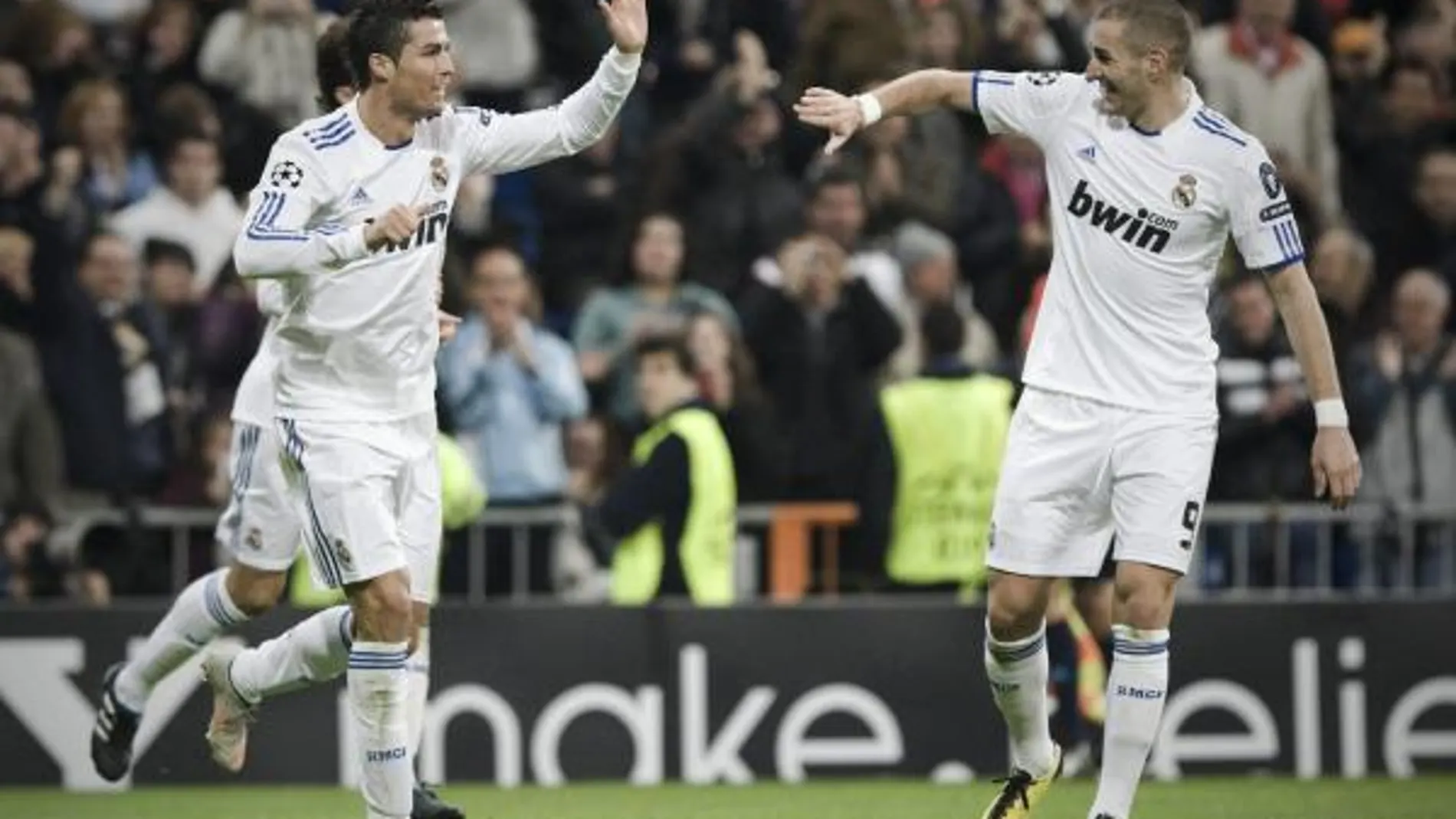 El delantero portugués del Real Madrid, Cristiano Ronaldo (i), celebra con su compañero Karim Benzema la consecución del segundo gol de su equipo frente al Auxerre