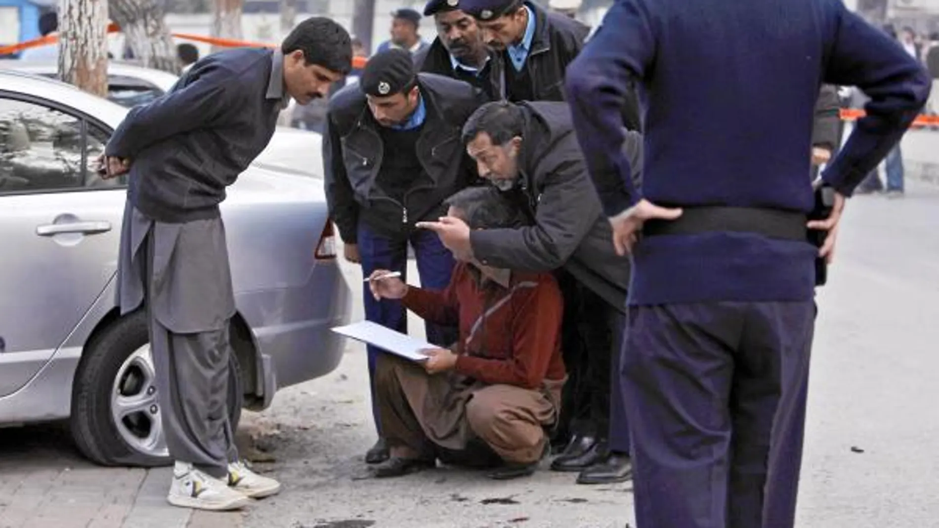 Agentes recogen pruebas en la escena del crimen, ayer en Islamabad