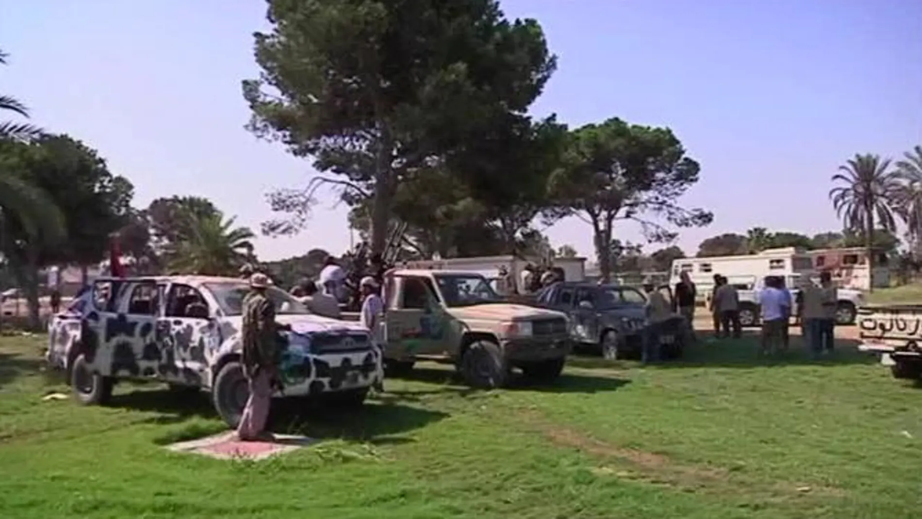 Rebeldes con sus vehículos en el cuartel general de Gadafi, Bab al-Aziziya, en Trípoli