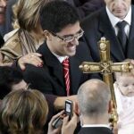 El papa Benedicto XVI acaricia a un niño momentos andes de la celebración de la misa