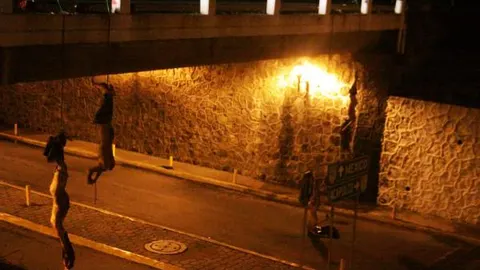 Los cuerpos de cuatro jóvenes decapitados se observan atados y colgando de un puente en la autopista México-Acapulco, en una zona de la ciudad central de Cuernavaca
