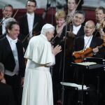 El papa Benedicto XVI, acompañado del maestro chileno Maximiano Valdés (i), saluda a los musicos de la Orquesta Sinfonica del Principado de Asturias (OSPA) tras finalizar el concierto