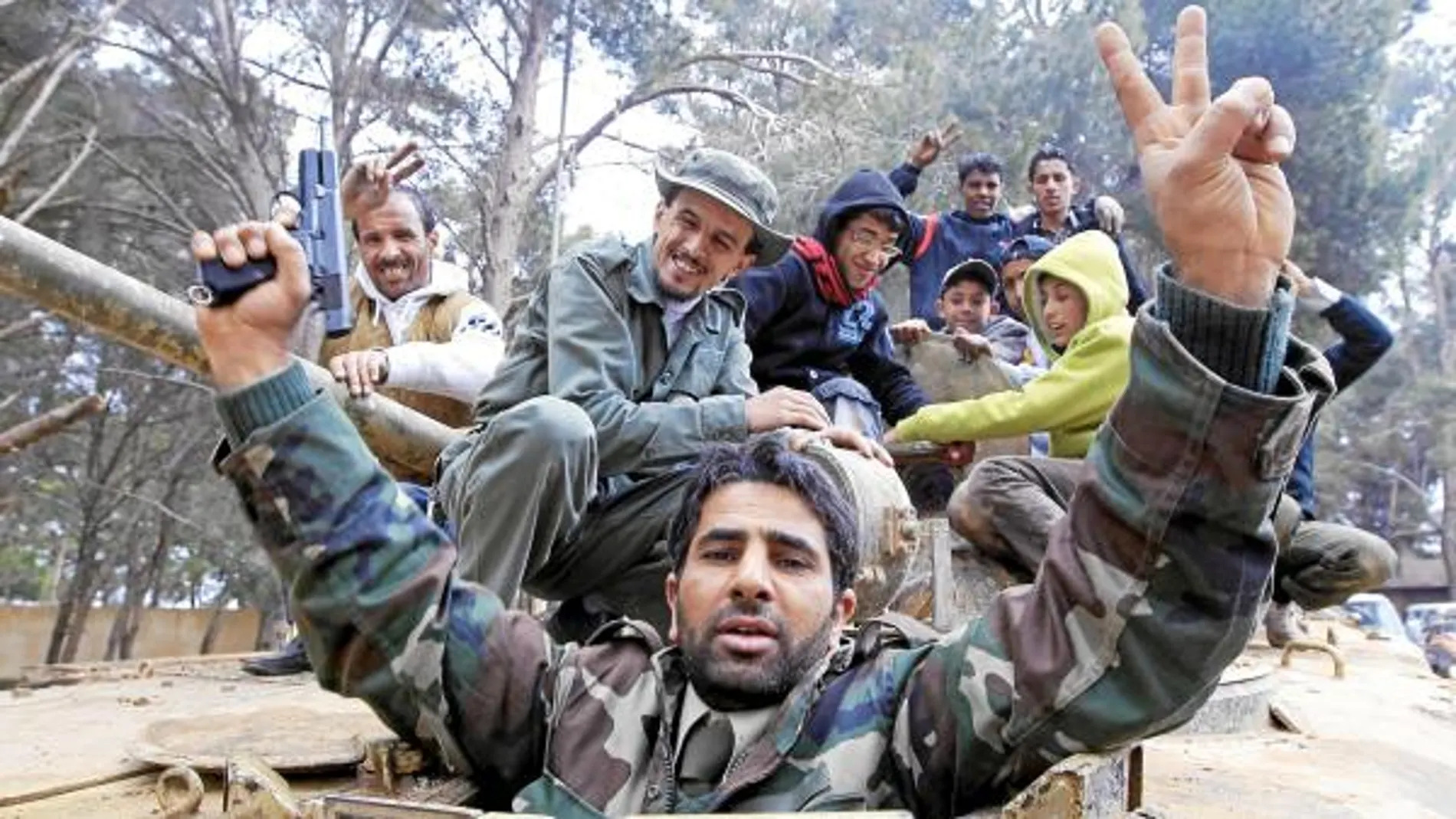 Un hombre celebra con otros milicianos la toma de la ciudad de Shahat, al este de Libia