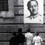 Dos niños miran un retrato de Franco
