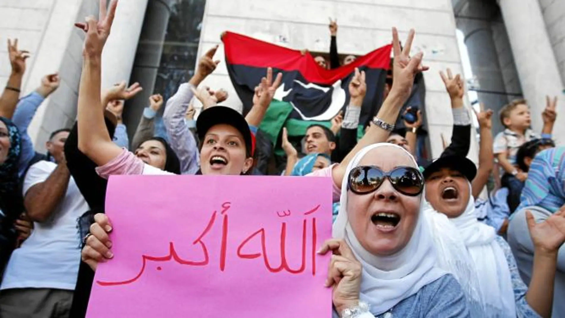 Un grupo de libios residentes en Túnez celebra, frente a su Embajada en la capital tunecina, la muerte del coronel Muamar Gadafi, ayer