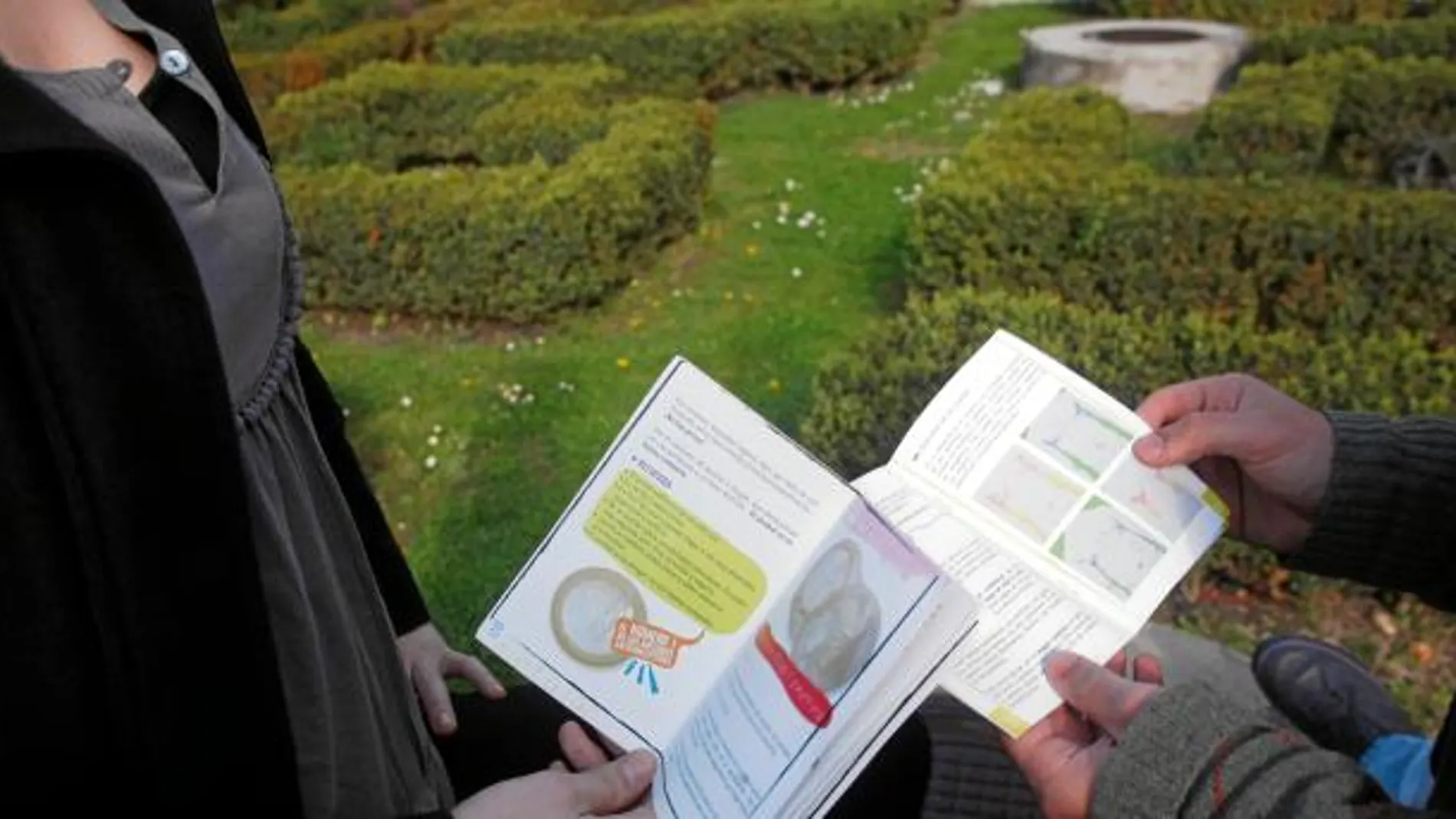 En la imagen, dos jóvenes leen el material educativo de un curso de sexualidad
