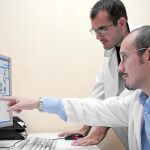 El doctor Vicente Villanueva (en primer plano), analizando la actividad cerebral de un paciente ingresado en la unidad de Vídeo Encefalografía (Vídeo EEG).