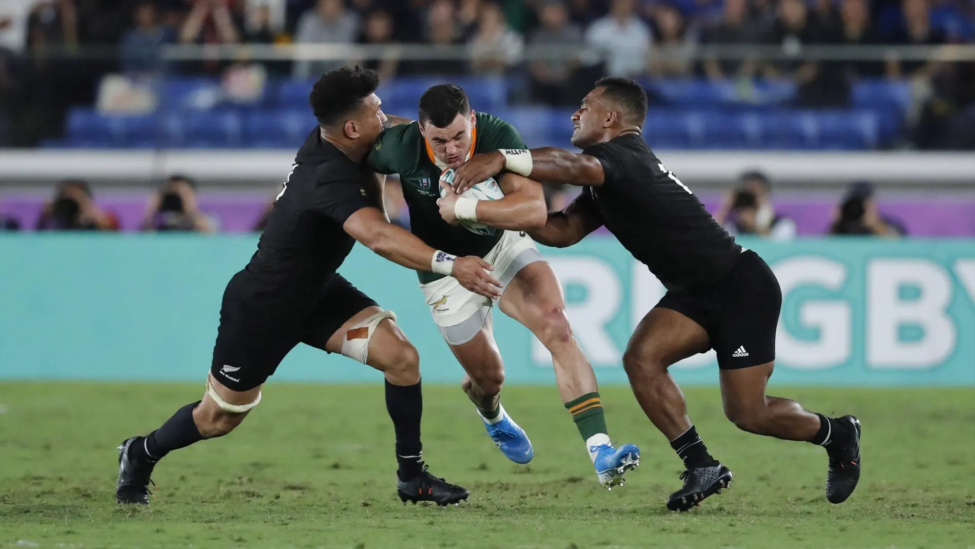 [South Africa's Jesse Kriel is tackled by New Zealand players during the Rugby World Cup Pool B game]