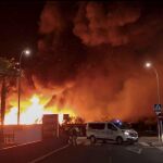 Imagen de las llamas producidas por el incendio que se ha originado poco antes de las diez de la noche en el asentamiento de inmigrantes ubicado junto al cementerio de Lepe, y que ha obligado a desalojarlo por completo / Efe