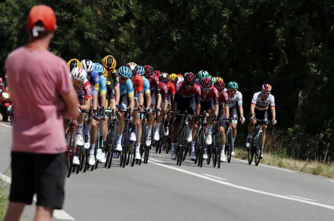 [A spectator watch the pack riding during the tenth stage of the Tour de France cycling race over]