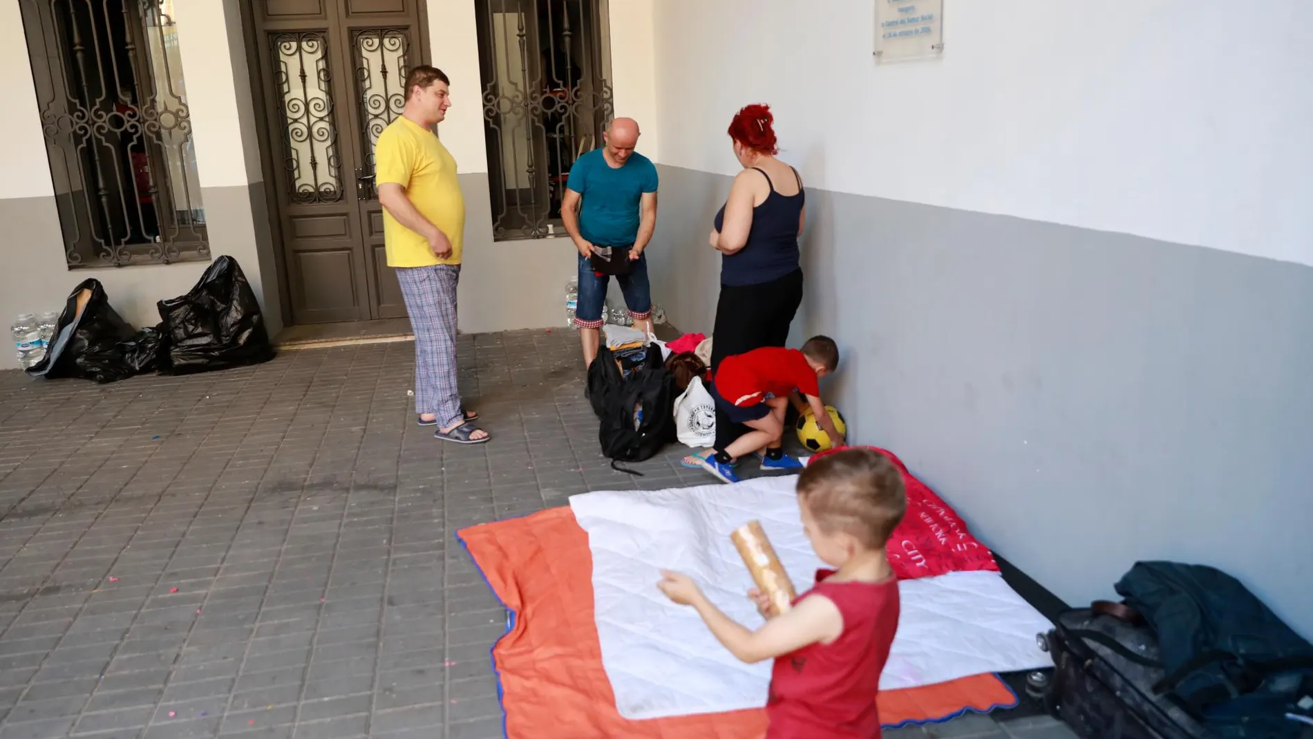Familias de refugiados con niños duermen en el patio del Samuel Social por la falta de recursos habitacionales.
