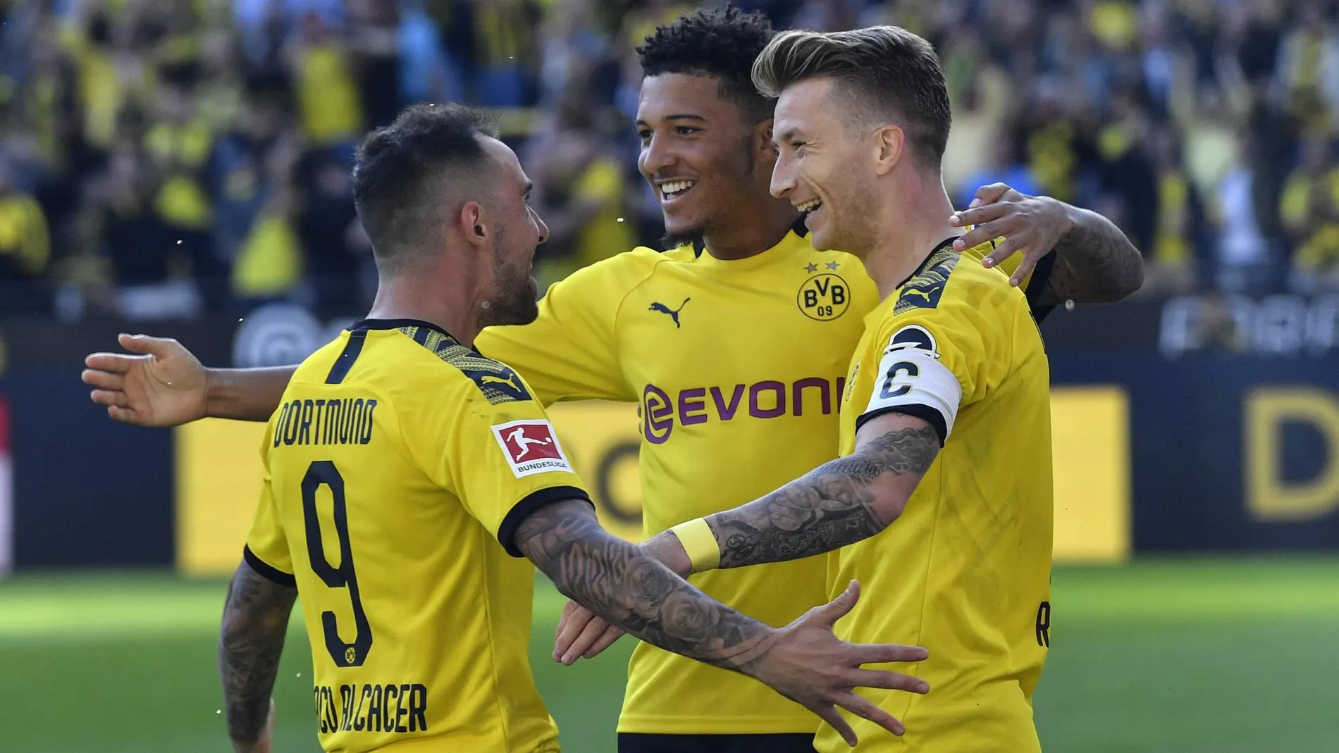 [Dortmund's Marco Reus, right, celebrates with Dortmund's Jadon Sancho, center, and Dortmund's Paco]