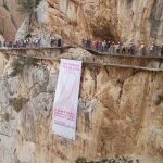 La lona gigante colocada en una de las paredes rocosas del desfiladero junto al balcón de cristal con un gran lazo rosa / Foto: La Razón