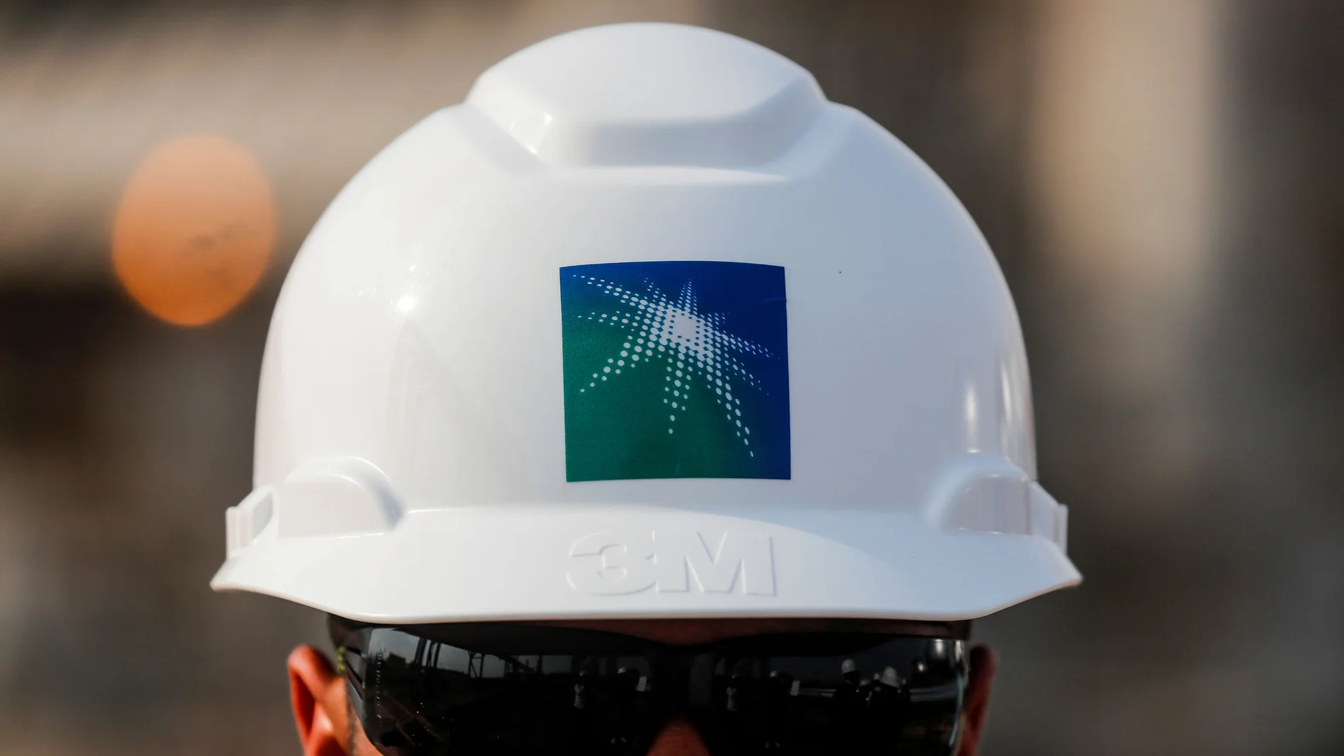 FILE PHOTO: An employee in a branded helmet is pictured at Saudi Aramco oil facility in Abqaiq