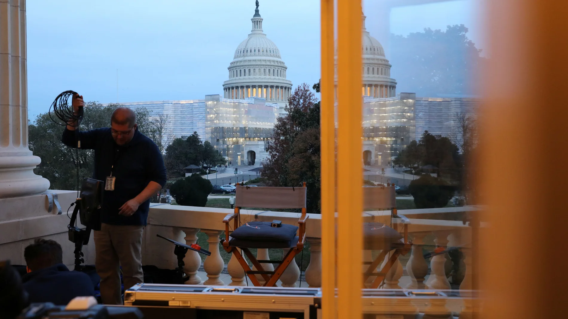 Television news crews work in the early morning hours ahead of testimony by former U.S. ambassador to Ukraine Yovanovitch before a House Intelligence Committee hearing as part of the Trump impeachment inquiry on Capitol Hill in Washington