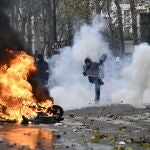 Un manifestante devuelve de una patada un bote de gas lacrimógeno durante las protestas hoy en París
