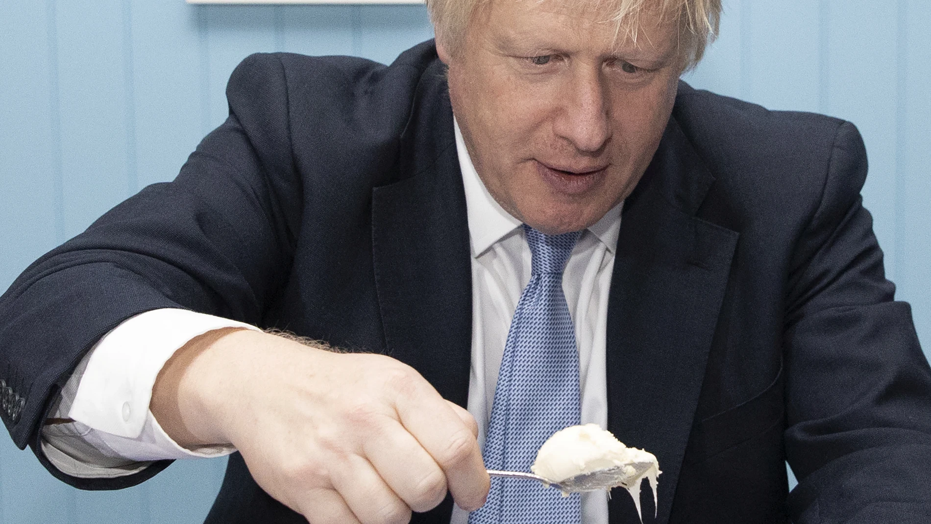 Britain's Prime Minister Boris Johnson enjoys a cream tea while touring 'Rodda's Clotted Cream', in Redruth