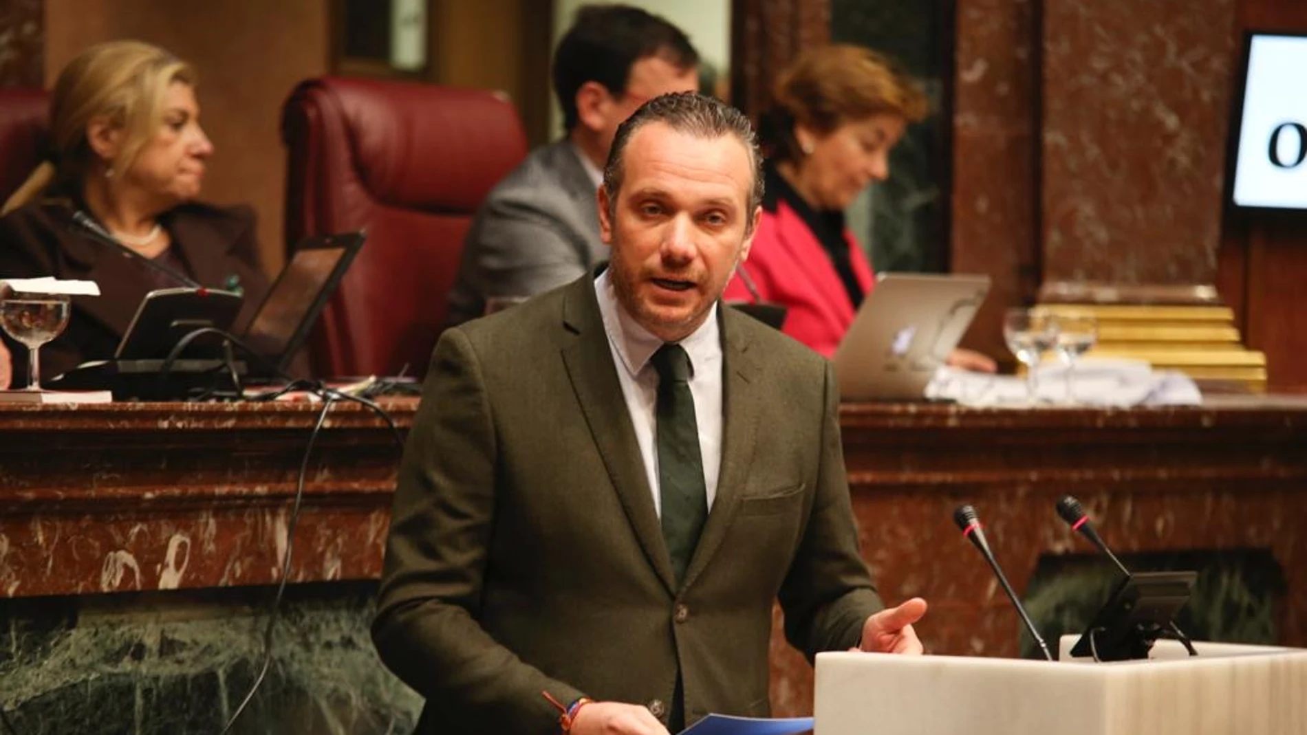 El portavoz parlamentario popular, Joaquín Segado, durante su intervención en la tribuna de la Asamblea Regional en defensa de la libertad de educación frente a las políticas de PSOE y Podemos