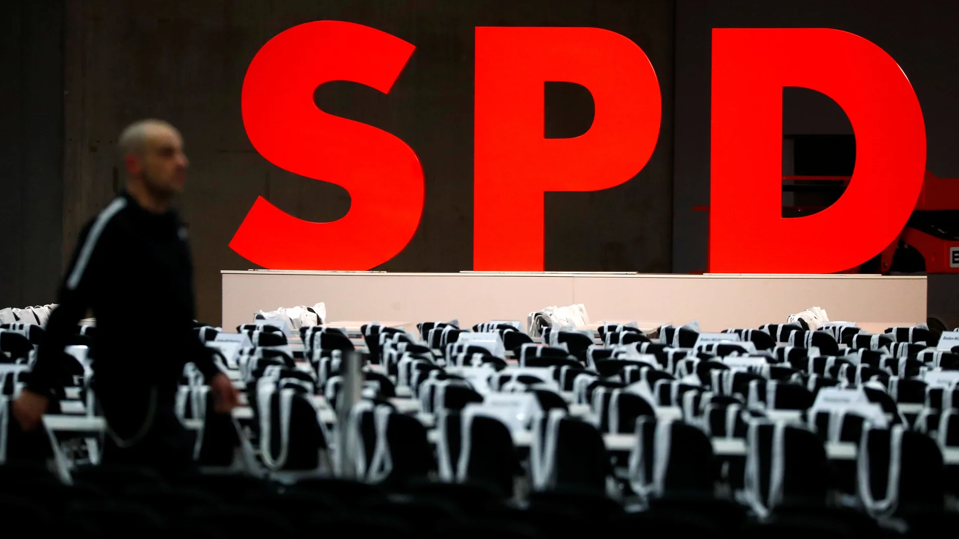 A worker walks past a party logo for the upcoming SPD party congress in Berlin