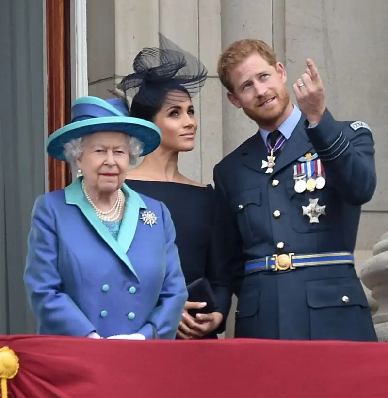 Queen Elizabeth II , with Prince Harry and Meghan Markle during the RAF Centenary at BuckinghamPalace, London