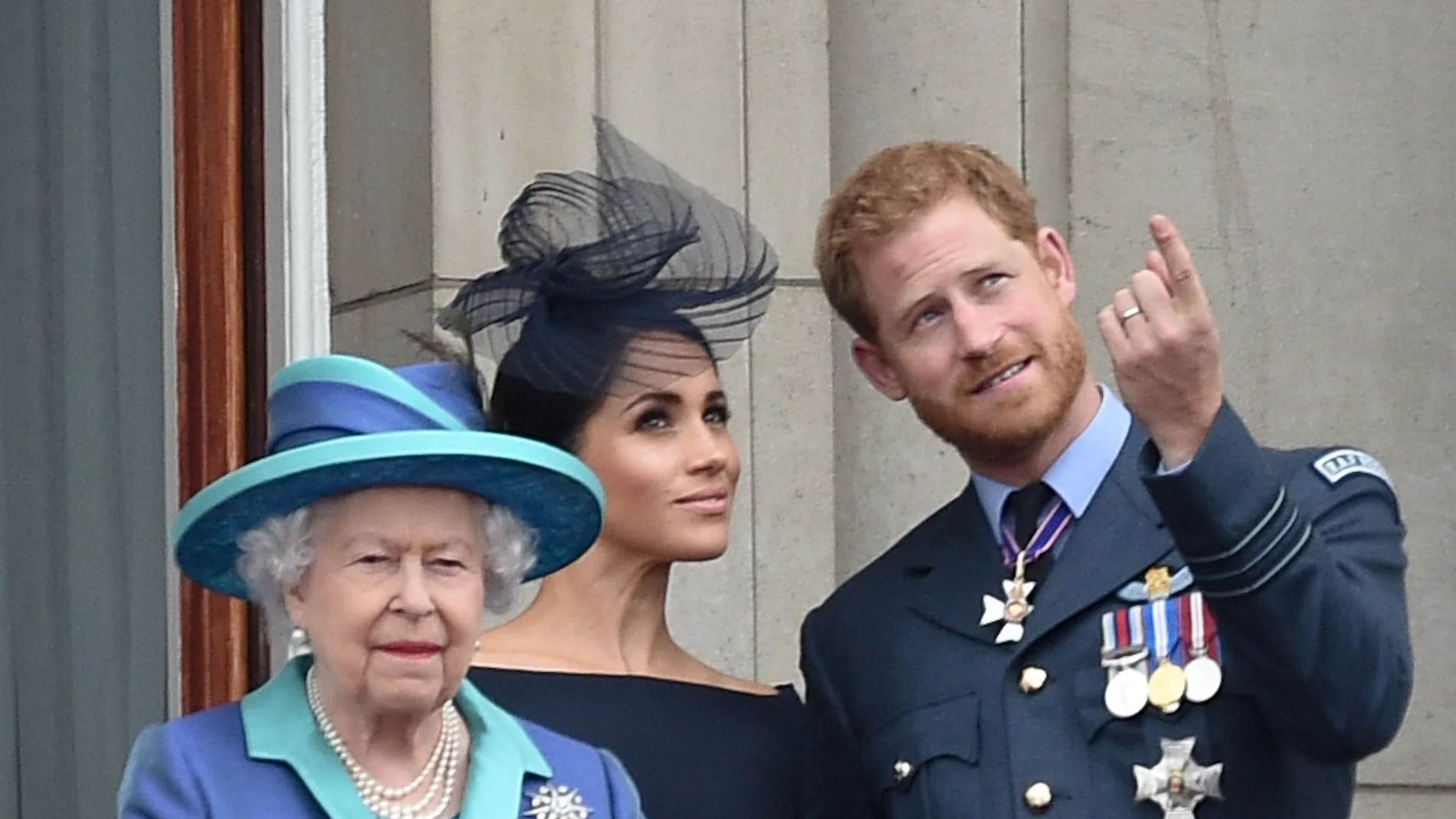 Queen Elizabeth II , with Prince Harry and Meghan Markle during the RAF Centenary at BuckinghamPalace, London