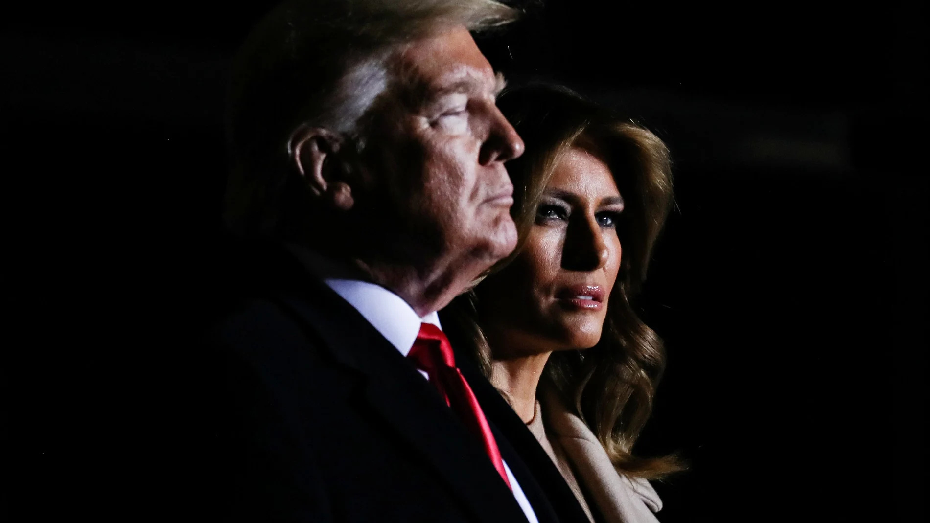 First lady Melania Trump looks on beside U.S. President Donald Trump as they attend a signing ceremony for the "National Defense Authorization Act for Fiscal Year 2020" at Joint Base Andrews