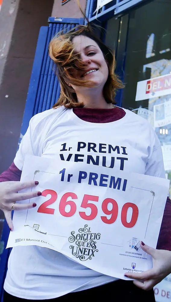 Laura Puentes , propietaria de la administración de lotería 249 de Barcelona, situada en el número 2 de la calle Guipúzcoa, posa con el premio Gordo de Navidad