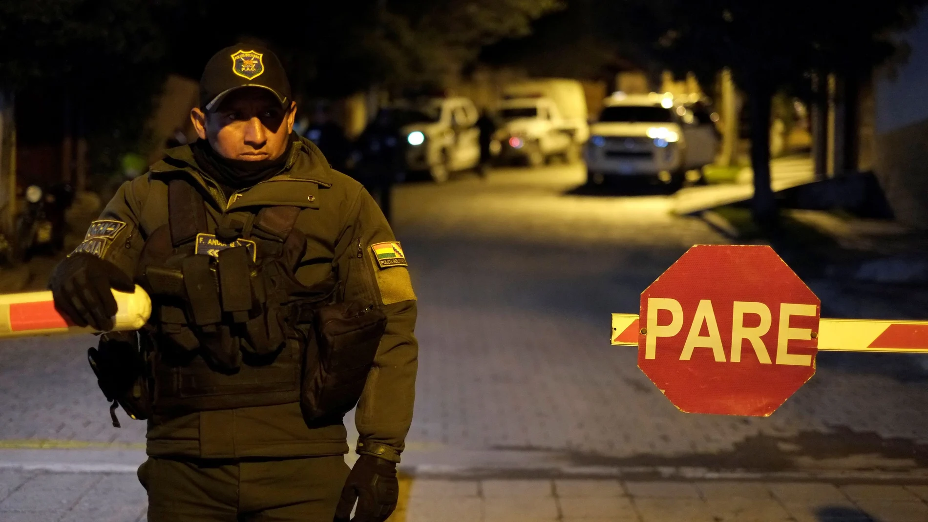 A police officer stands guard at the entrance of the Urbanizacion La Rinconada, where the residence of Mexico's ambassador is located, in La Paz
