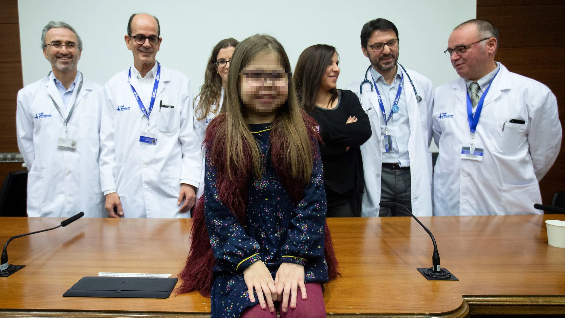 GRAFCAT9467. BARCELONA, 03/01/2020.- Iria, una niña de 10 años con una mutación genética ultrarrara y que se ha convertido en el primer paciente pediátrico triple trasplantado de corazón, hígado y riñón de España, posa junto a su madre, Judith (3d), y el equipo médico que la ha tratado, momentos antes de la rueda de prensa que han ofrecido en el Hospital Vall d'Hebron de Barcelona. EFE/Enric Fontcuberta.