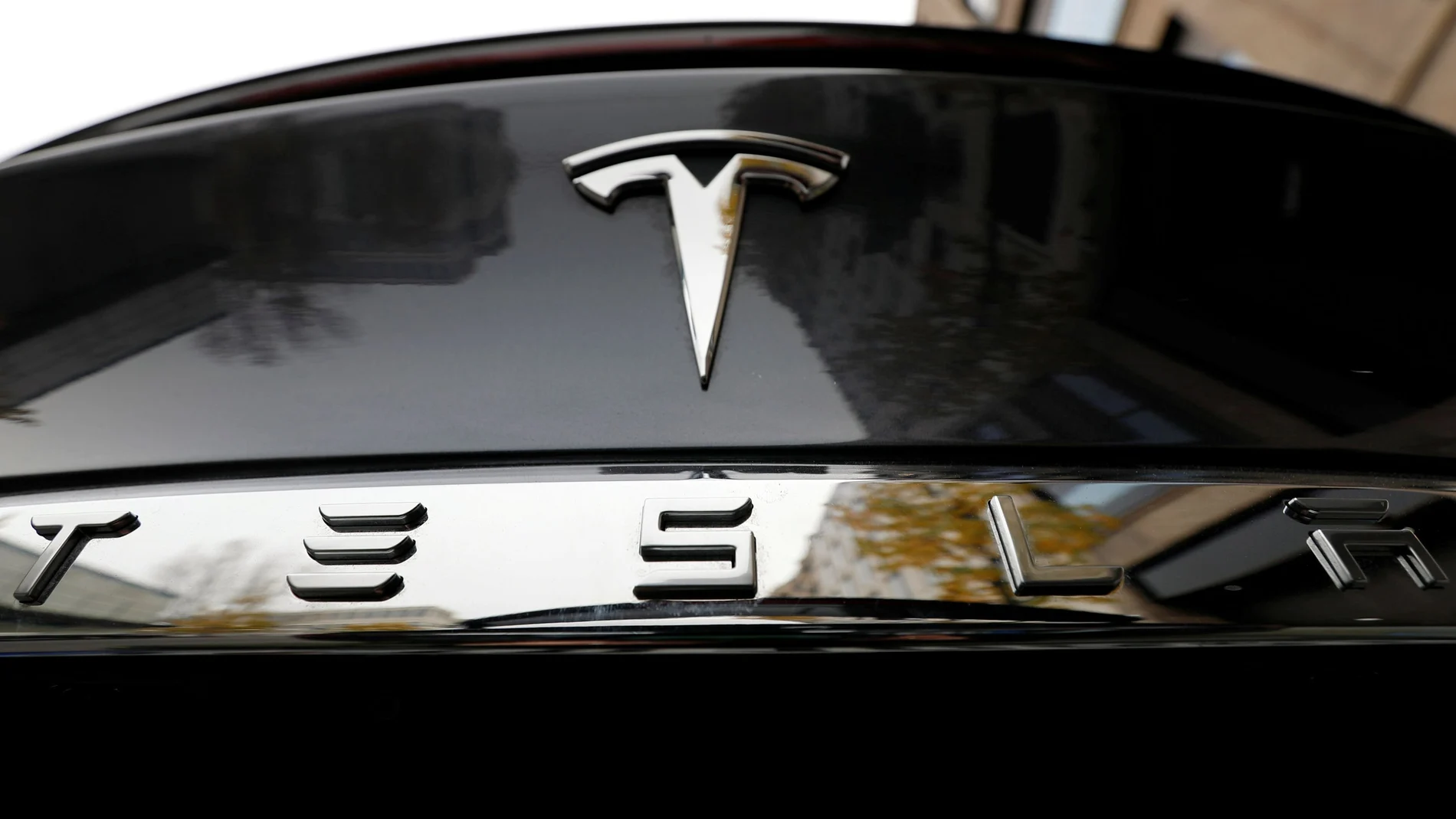 FILE PHOTO: The company logo is pictured on a Tesla Model X electric car in Berlin