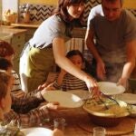 Man and woman serving children at table