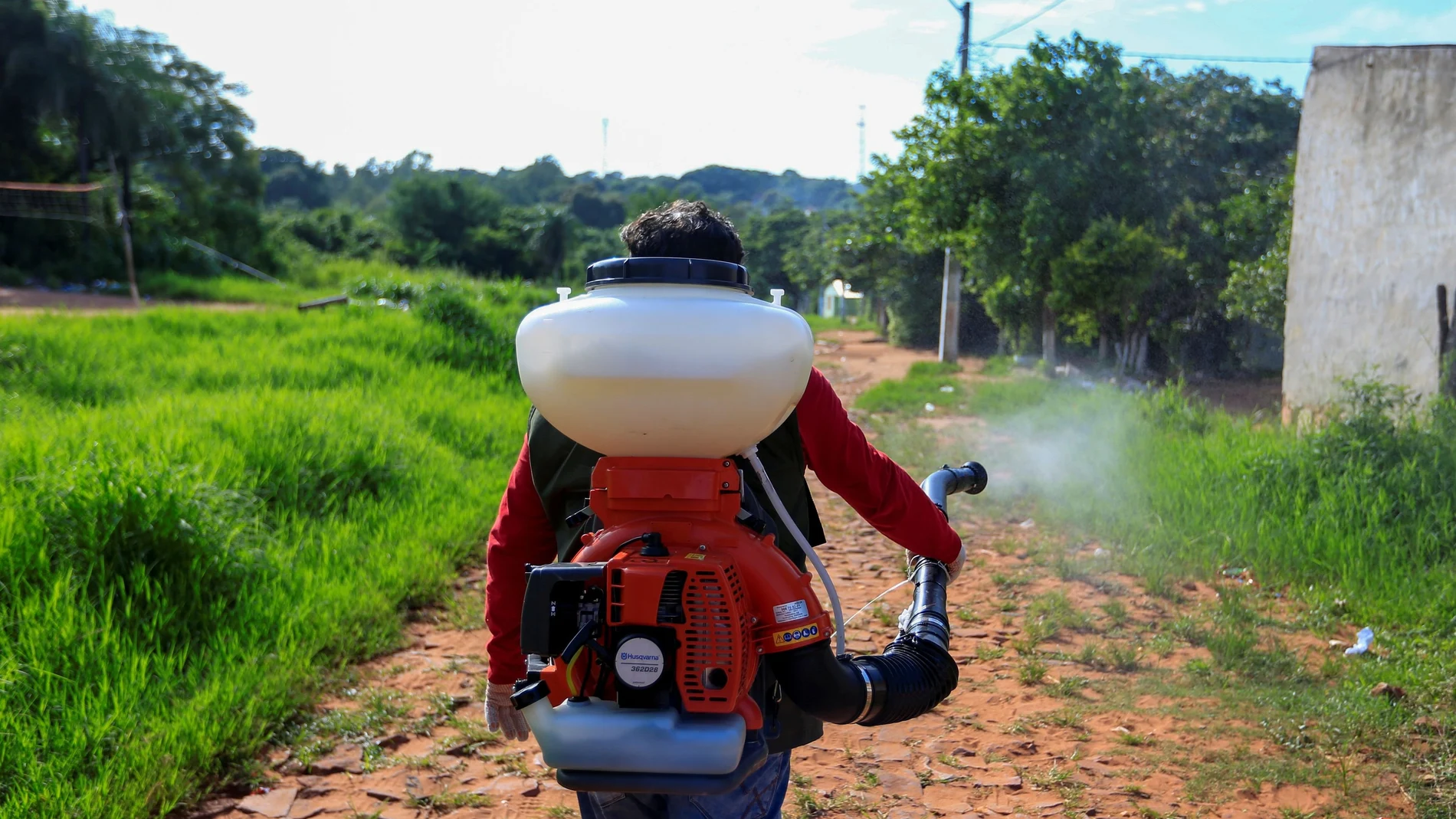 A worker from the National Malaria Eradication Service (SENEPA) fumigates a neighbourhood to prevent the spread of dengue fever, on the outskirts of Asuncion