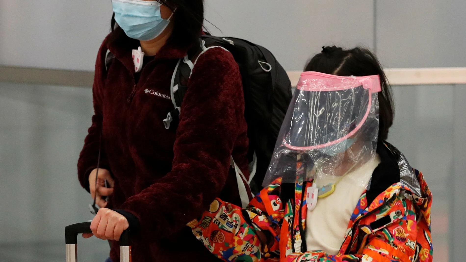 A child wears self made mask as she arrives at Hong Kong West Kowloon High Speed Train Station Terminus, before temporary closing, following the coronavirus outbreak in Hong Kong