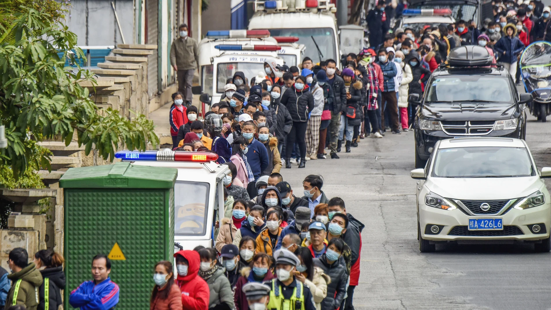 People line up to buy face masks from a medical supply company in Nanning in southern China's Guangxi Zhuang Autonomous Region, Wednesday, Jan. 29, 2020. Countries began evacuating their citizens Wednesday from the Chinese city hardest-hit by a new virus that has now infected more people in China than were sickened in the country by SARS. (Chinatopix via AP)