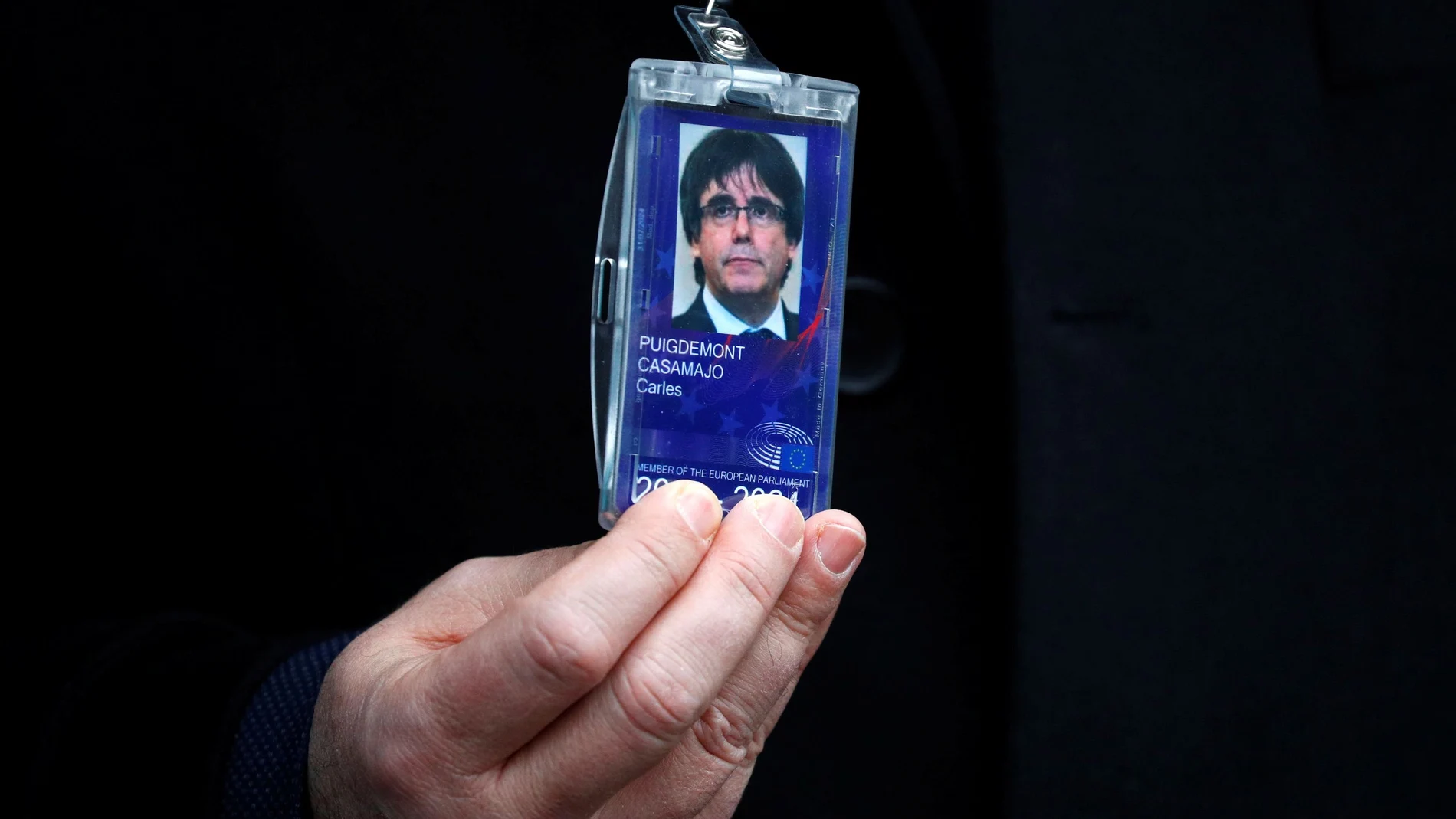 Former member of the Catalan government Puigdemont shows his badge outside the EU Parliament in Brussels
