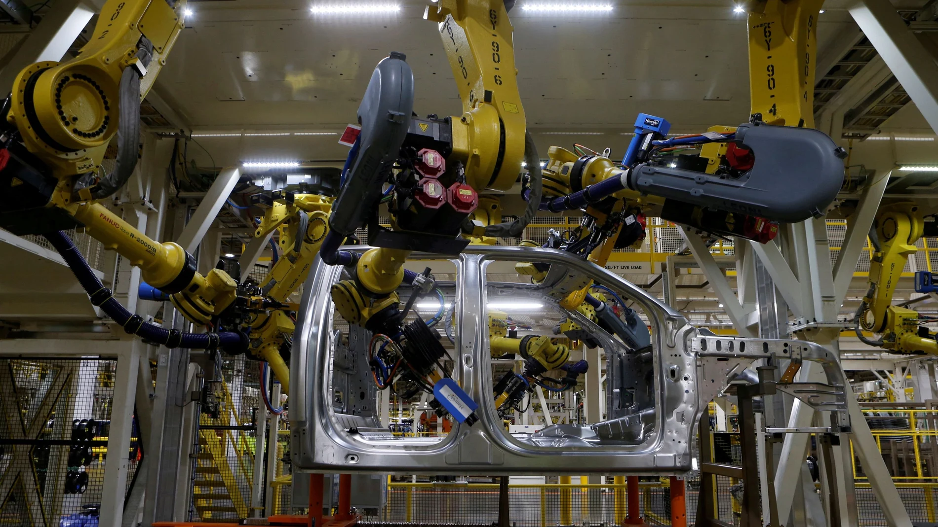 FILE PHOTO: File photo of the aluminium cab of the then all-new 2015 F-150 pick-up truck moves down the robot assembly line at the Ford Rouge Center in Dearborn, Michigan