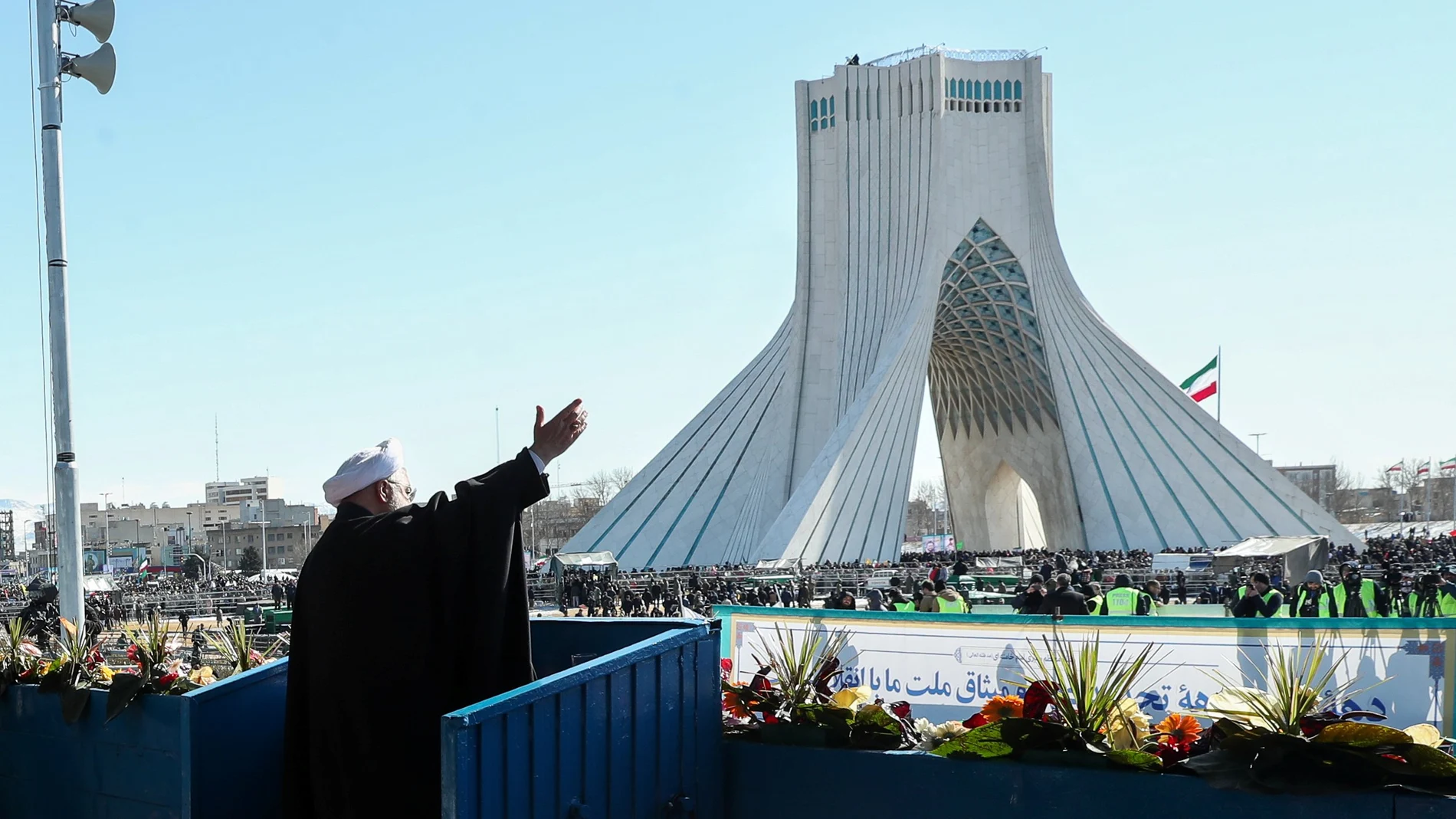 Iranian President Hassan Rouhani salutes the crowd during the commemoration of the 41st anniversary of the Islamic revolution in Tehran