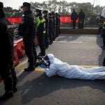 Reuters video journalist Martin Pollard wears a protective suit as he films at the Jiujiang Yangtze River Bridge in Jiujiang