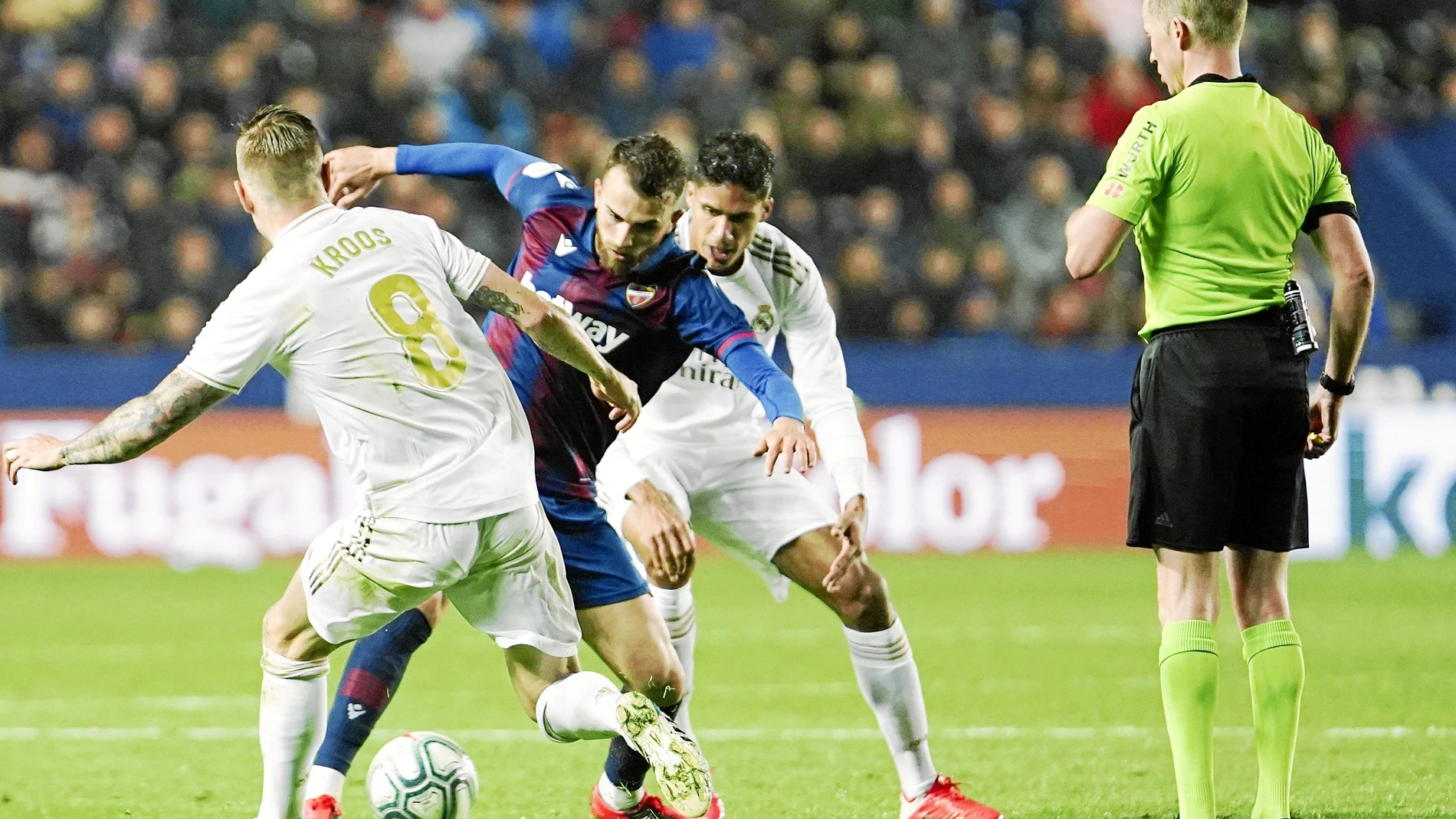 Levante's Borja Mayoral, second left, and Real Madrid's Toni Kroos, left, challenge for the ball during the Spanish La Liga soccer match between Levante and Real Madrid at the Ciutat de Valencia stadium in Valencia, Spain, Saturday, Feb.22, 2020. (AP Photo/Alberto Saiz)